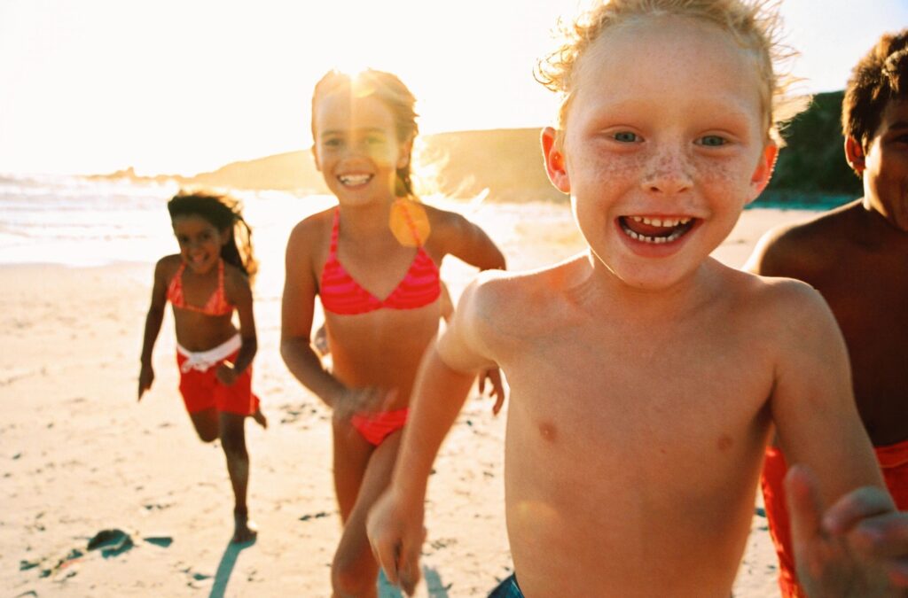 Kids playing on the beach at Higgins Lake